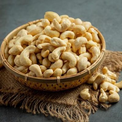Top grade whole cashew nuts in a bowl on burlap