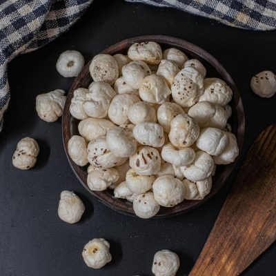 Premium quality Makhana (Fox Nuts) in a black bowl on dark background